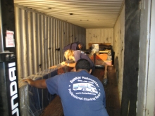 Loading Josephine Meckseper’s pump jack art exhibit into 40-foot ocean freight containers for transport to Europe